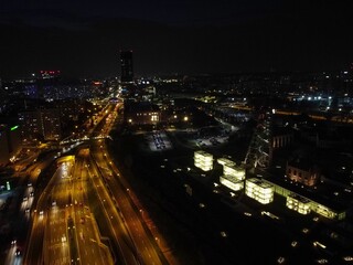 Aerial shot of roads in the middle of city buildings at night in Katowice, Poland