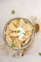 Dumplings, filled with cherries, berries. Pierogi, varenyky, vareniki, pyrohy - dumplings with filling