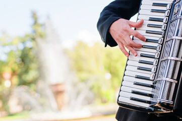 Accordion. Keys. Male hand on the accordion. - obrazy, fototapety, plakaty