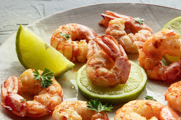 Shrimps close-up. Fried shrimp with lime on a plate. Spicy seafood appetizer