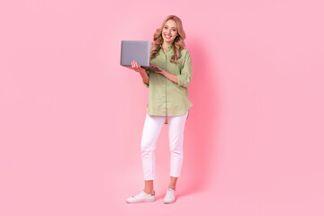 Full length photo of sweet cute woman dressed green shirt communicating modern gadget isolated pink color background
