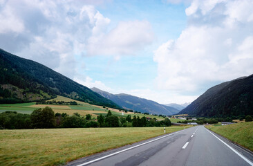 Naklejka premium Asphalt road in Alp mountains. Road trip concept. Beautiful landscape.