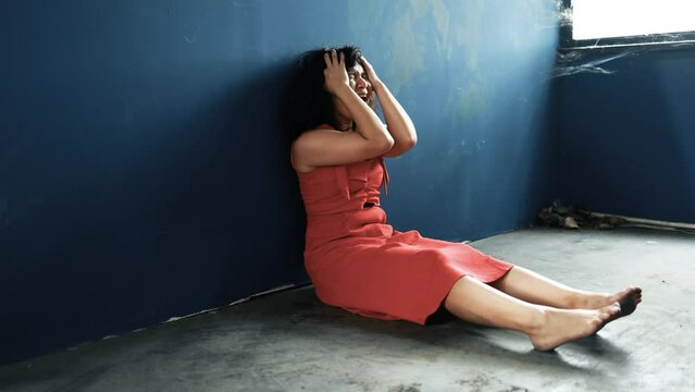 beaten young asian woman screams in terror and loses consciousness.