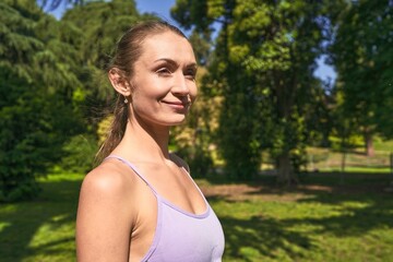 In her sportswear, a woman finds her stride amidst the park's greenery.