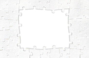 Frame made of white puzzles. Business background. Blank space for your text. Paper texture. Design 