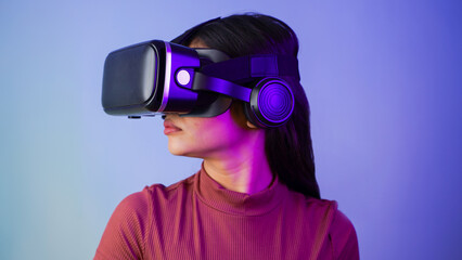 Young Asian Indian woman wearing virtual reality headset, a girl with VR glasses concept studio portrait