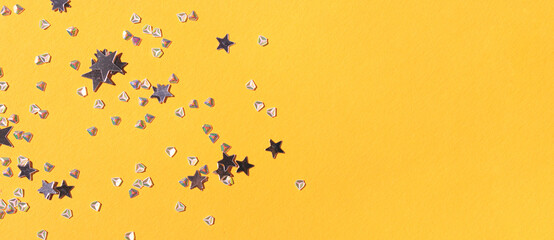 Banner with glowing stars and crystals confetti on a bright yellow background. Place for text.