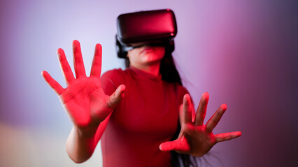 Young Asian Indian woman scared, wearing virtual reality headset, a frightened girl with VR glasses...