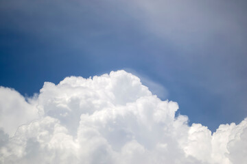 Incredible clouds against the blue sky. White, curly clouds stand out in the blue sky. Clouds...