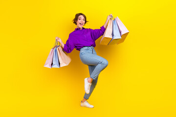 Full length body photo of young carefree addicted shopaholic woman wear formal clothes hold bags boutique isolated on yellow background - obrazy, fototapety, plakaty