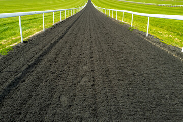 Wide angle, shallow depth of field of a flat racing horse racing track seen looking down to the...