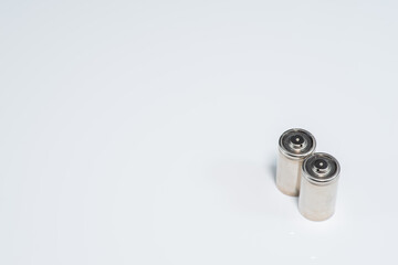 Alkaline batteries lie on white background, The concept of vital energy reserve