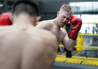 Two male athlete boxing competition in ring. Diverse ethnic men kick fighting in kickboxing...