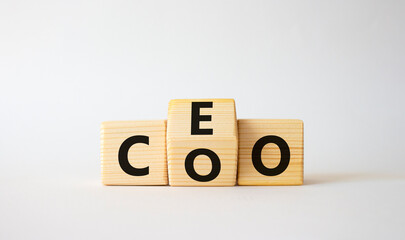 CEO and COO symbol. Turned wooden cubes with words CEO and COO. Beautiful white background. CEO and COO and business concept. Copy space