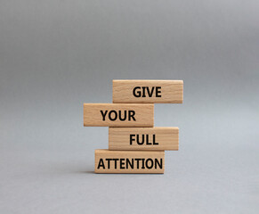 Give your full Attention symbol. Concept word Give your full Attention on wooden blocks. Beautiful grey background. Business and Give your full Attention concept. Copy space