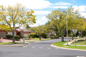 Fototapeta na wymiar A typical suburban street with beautiful trees and houses lined along the road in an Australian residential neighbourhood. Melbourne VIC Australia