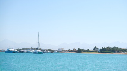 Serenity Unveiled: A Mesmerizing Sunset at Sea with Graceful Boats Amidst the Golden Hues, an Enchanting Moment of Tranquility and Nautical Beauty in Hurghada , El gouna , Egypt 