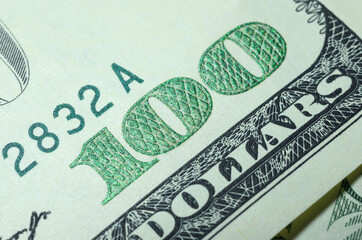 Part of the one hundred USA dollar banknote with number 100 close up and writing Federal Reserve Note