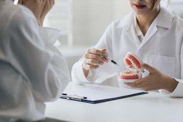 Patient with a toothache sees a dentist in a dental clinic at a hospital examination room. The...