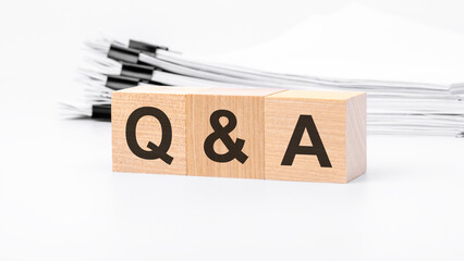 Q and A wooden blocks word on white background. QA - short for Question and Answer, business...