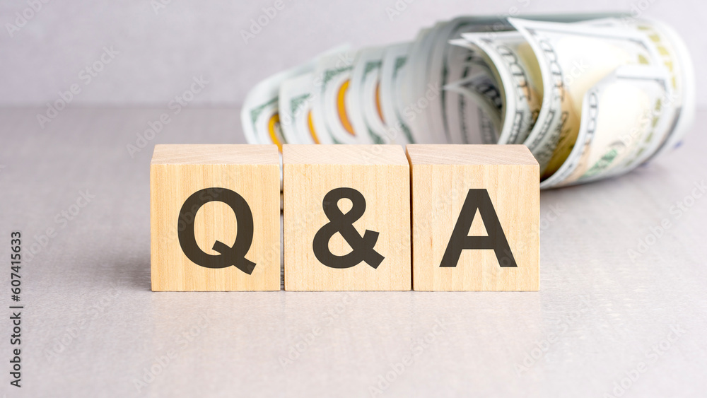 Poster word qa on wooden cubes, grey background