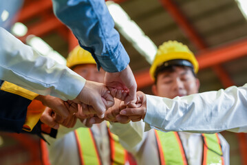 Group of young Engineer United stack hands or join hand teamwork together with Spirit diversity...