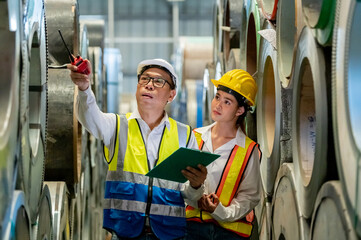 Factory apprenticeship. Man mentor teaching Female employees trainee operating machine looking...