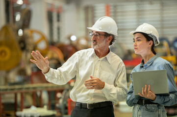 partner woman engineer assistant in helmet inspection check heavy machine construction installation...