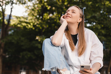 People emotions, lifestyle leisure and beauty concept. Dreamy and excited happy young blonde woman using mobile phone, smiling and looking thoughtful at side, have idea, search solutions, thinking.