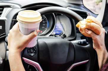 forbidden and perilous with close-up of woman's hand, holding burger and coffee, engaged in...