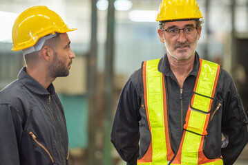Two professional engineer worker technician assistant in helmet inspection check old machine construction factory with colleague manager. check old machinery production construction operating