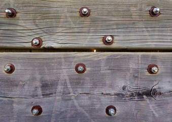 texture of a vintage wooden wall made of planks with cracks and nails