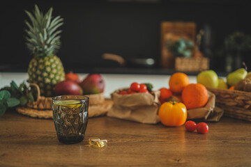 Obraz na płótnie Canvas Glass of water with lemon and vitamins, healthcare concept