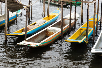 Fototapeta na wymiar Fishing canoes docked on the Almas River in the city of Taperoa, Bahia.