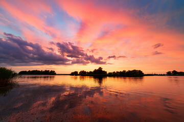 stunning landscape with bright red clouds and their watery reflections