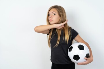 beautiful caucasian teen girl wearing sportswear  over white wall cutting throat with hand as...