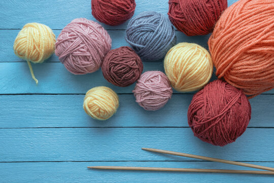Hobbies and knitting concept. Balls of wool and  knitting needles on  rustic table. Copy space