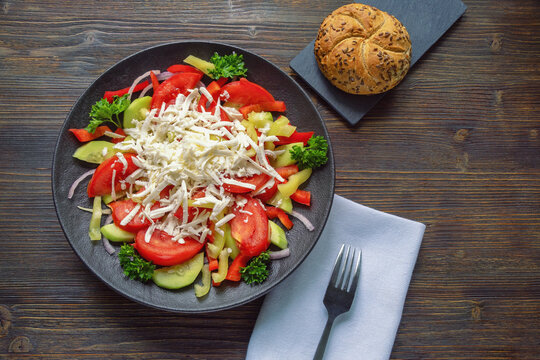 Balkan cuisine. Shopska Salad, traditional dish of Balkan, on dark rustic table. Copy space