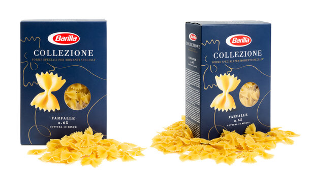 Munich, 05.22.2023: box of Italian Barilla brand "farfalle" (butterflies) pasta surrounded by the actual product / noodles isolated over transparency, "collezione" series, two perspectives