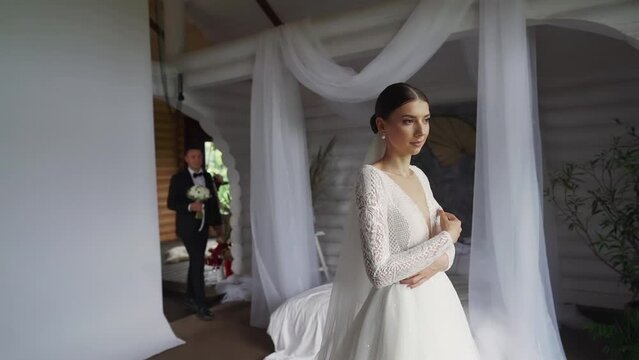 Bride waiting for the groom. Wedding day. First look in the photo studio