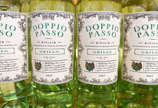 Viersen, Germany - May 9. 2023: Closeup of bottles sicilian Doppio Passo Grillo white wine in shelf of german supermarket