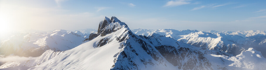 Rugged Canadian Mountain Peak Covered in Snow. Aerial Landscape