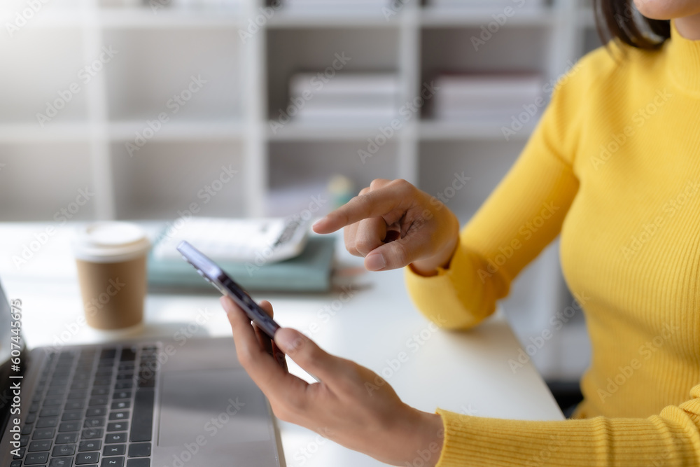 Poster close-up of a woman using a smartphone to work on various application including mobile transaction t