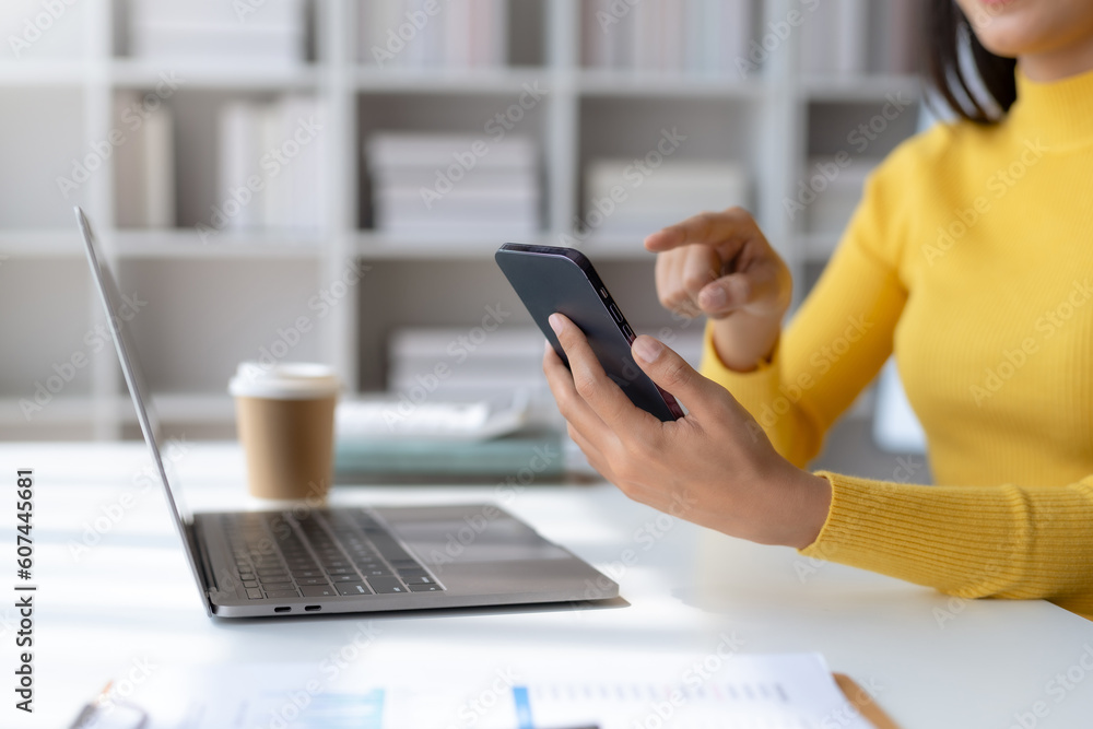 Poster close-up of a woman using a smartphone to work on various application including mobile transaction t
