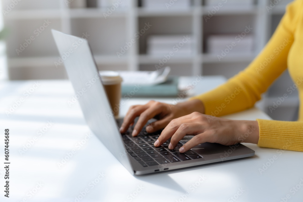 Poster close-up of hand of businesswoman working using laptop computer to record and print information for 