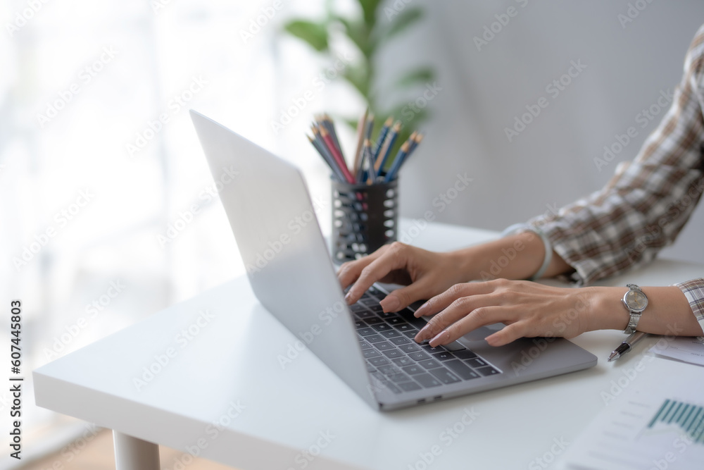 Poster close-up of hand of businesswoman working using laptop computer to record and print information for 