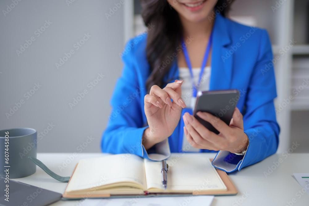 Poster close-up of a woman using a smartphone to work on various application including mobile transaction t