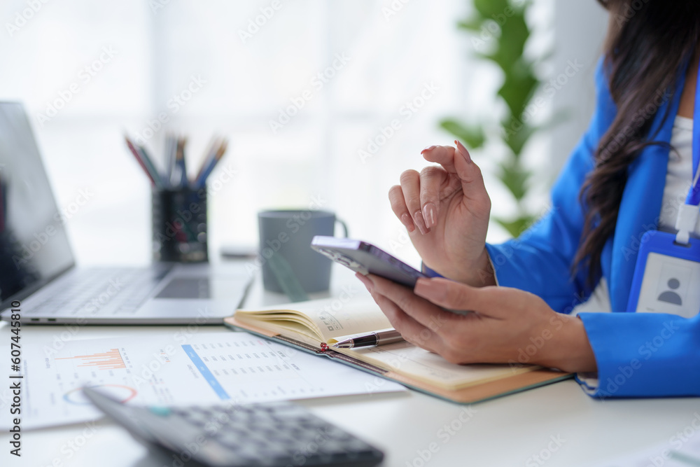 Poster close-up of a woman using a smartphone to work on various application including mobile transaction t