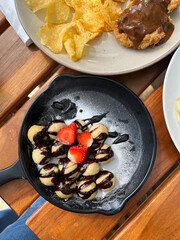 A plate of food with bananas and strawberries on it 