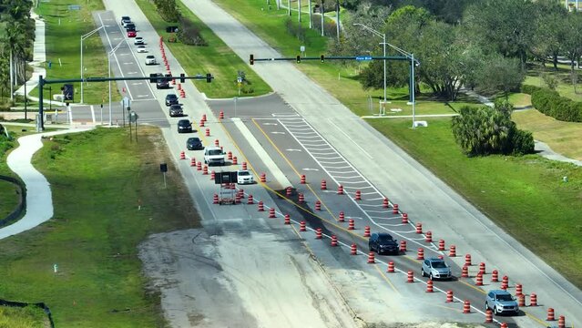 Construction roadworks on american transport infrastructure. Renovation of highway road with moving traffic. Development of interstate transportation concept